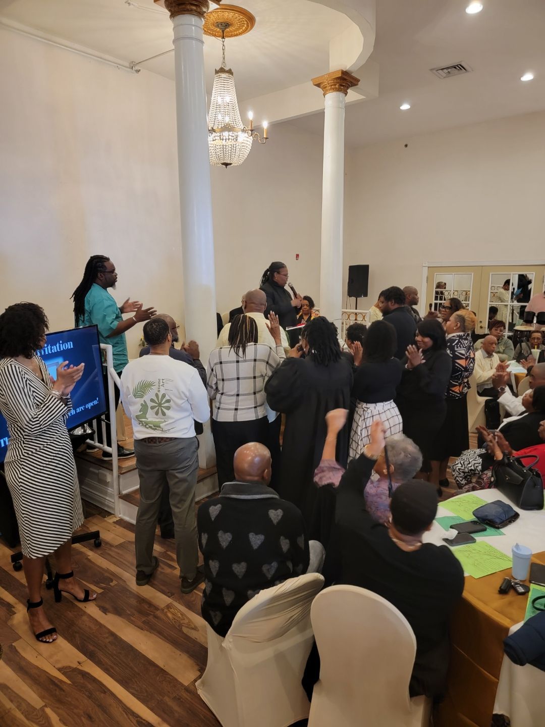 A large group of people are gathered in a room.