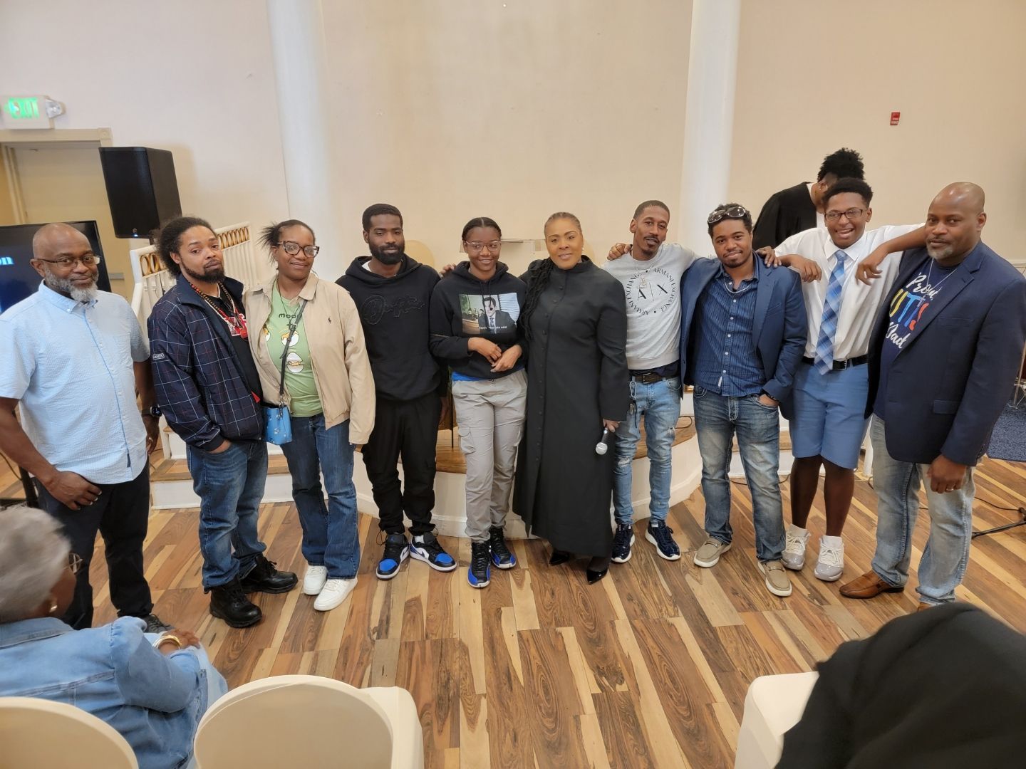 A group of people are posing for a picture in a room.