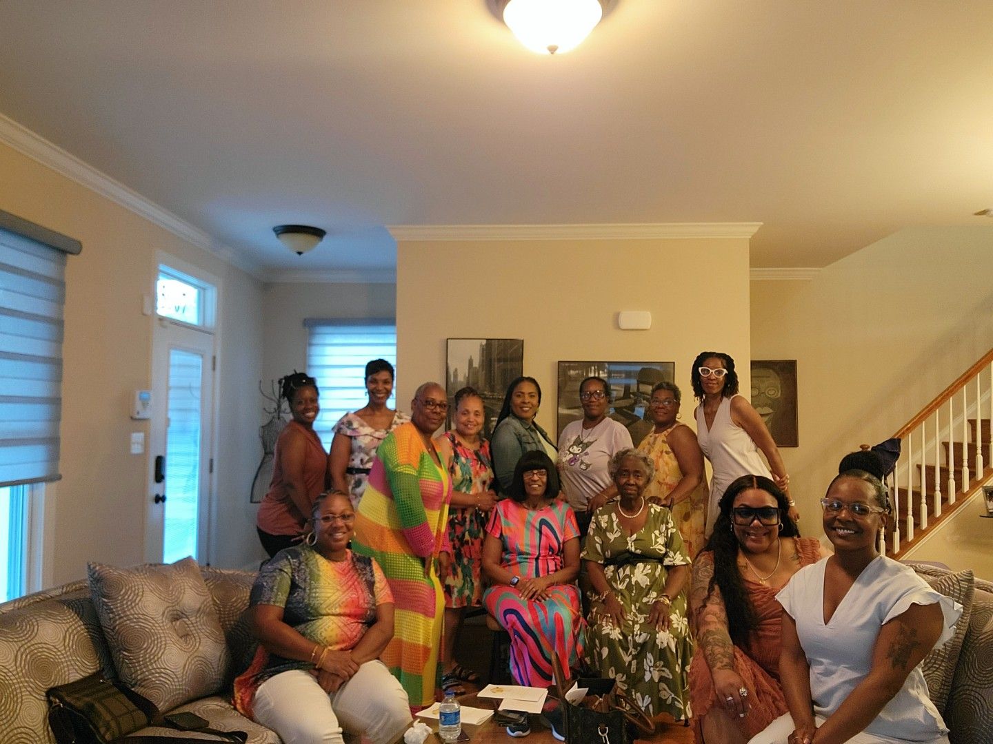 A group of women are posing for a picture in a living room.