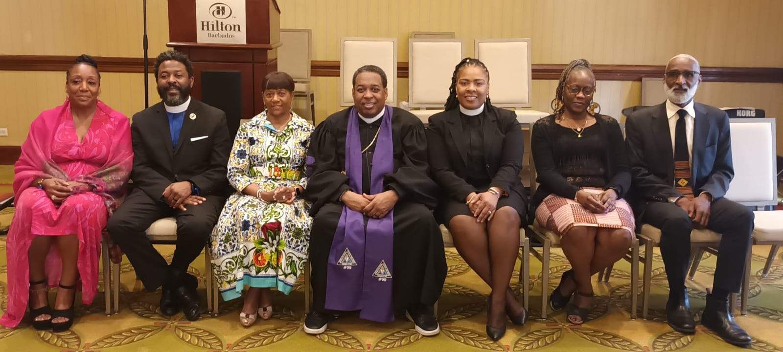 A group of people are sitting in chairs posing for a picture.