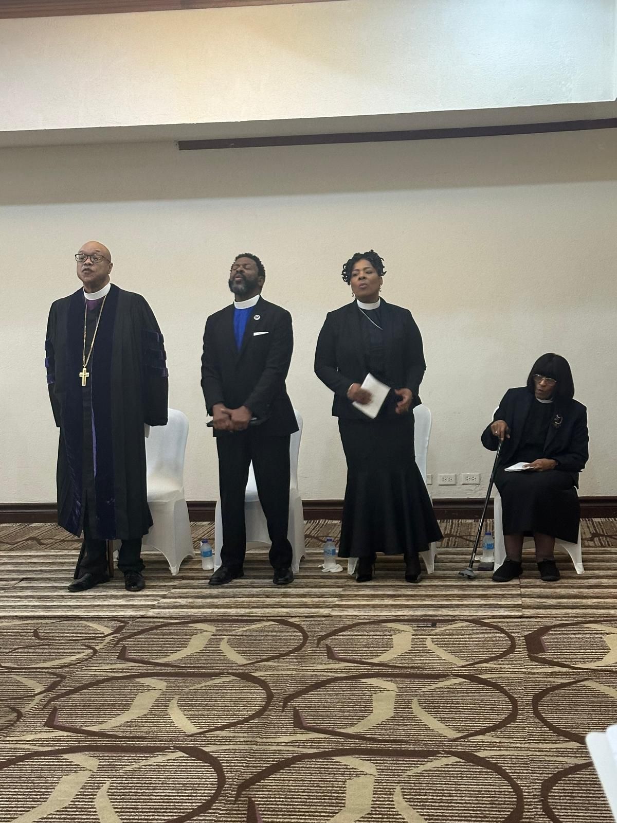 A group of people standing next to each other in a room.