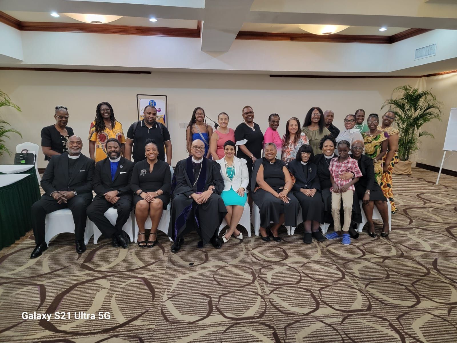 A group of people are posing for a picture in a room.