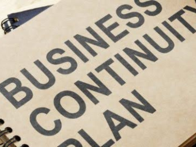 A business continuity plan is written on a piece of paper