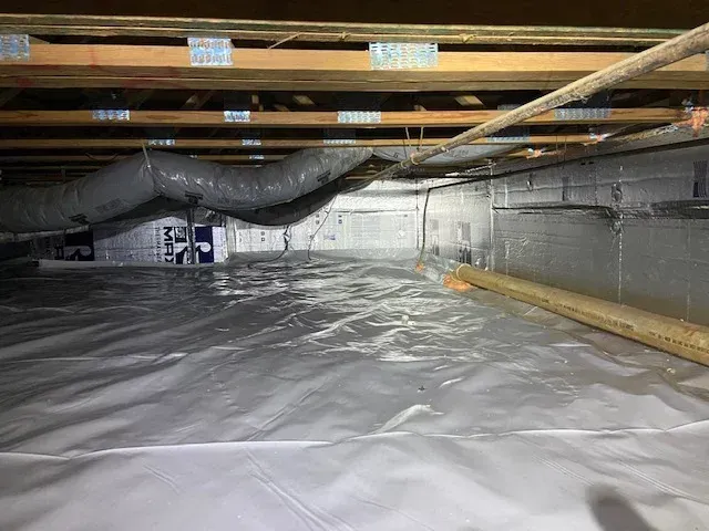 The inside of a moving truck filled with boxes and blankets.