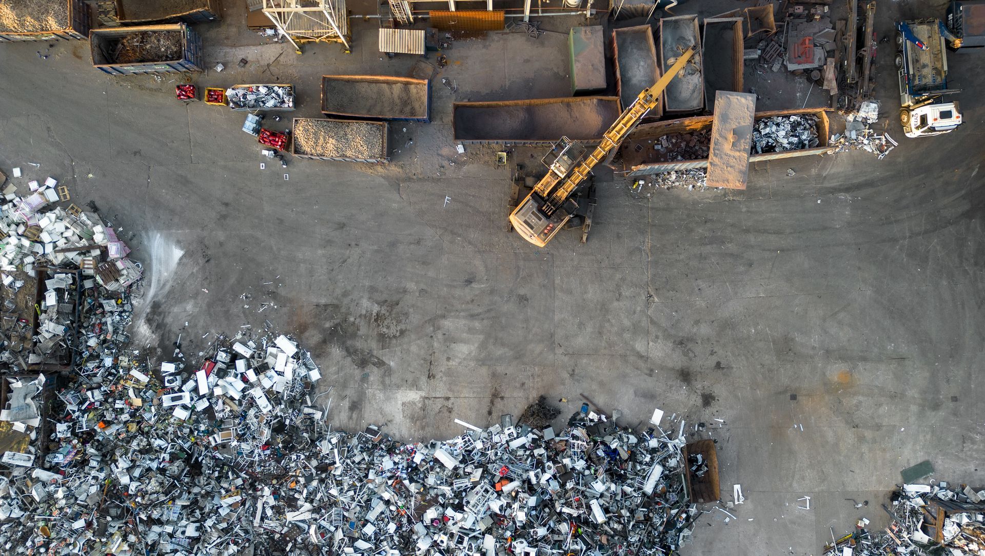 Overhead aerial view of waste metals being sorted at a scrap metal yard before the recycling process
