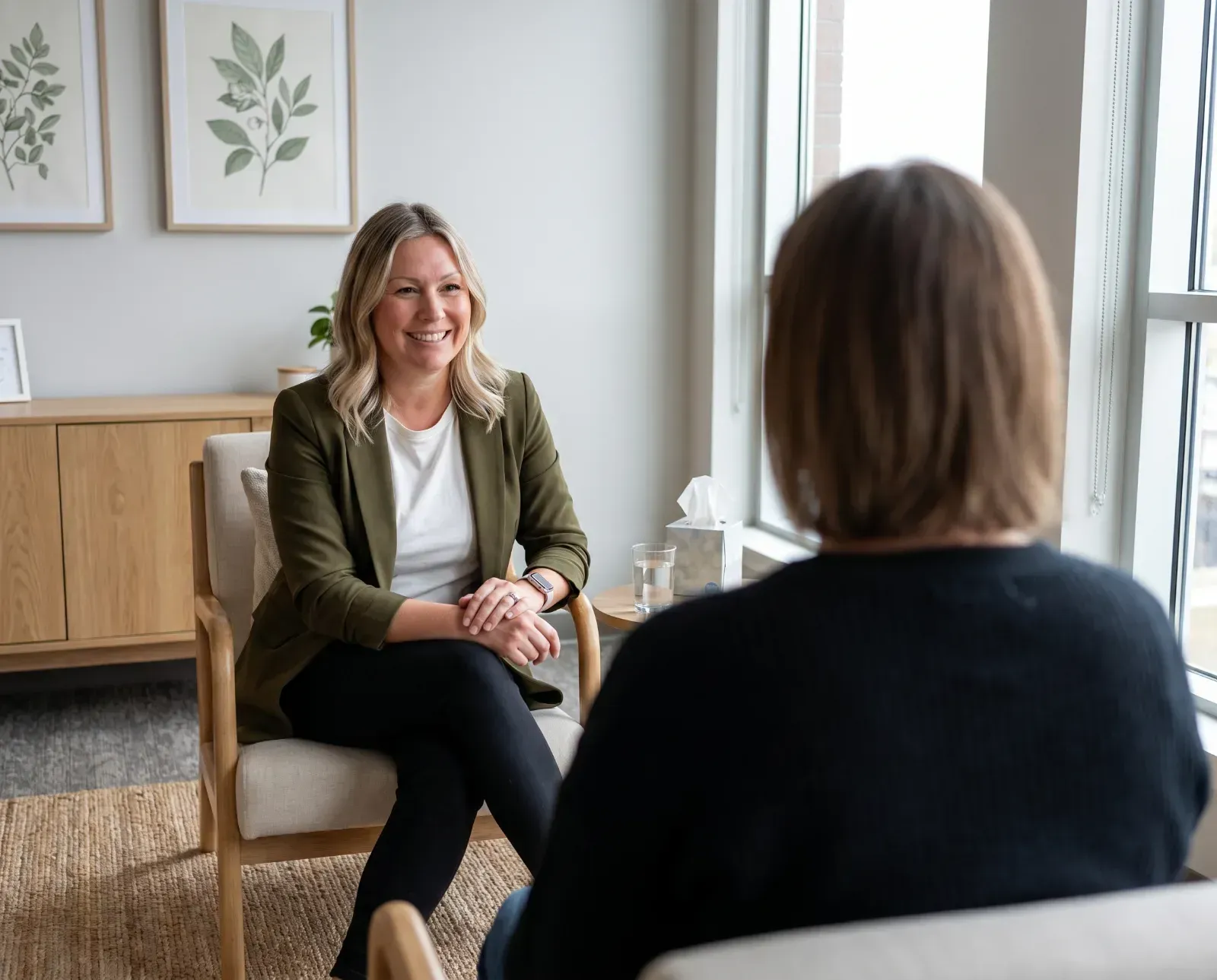 Therapist smiling at her client while having a conversation.
