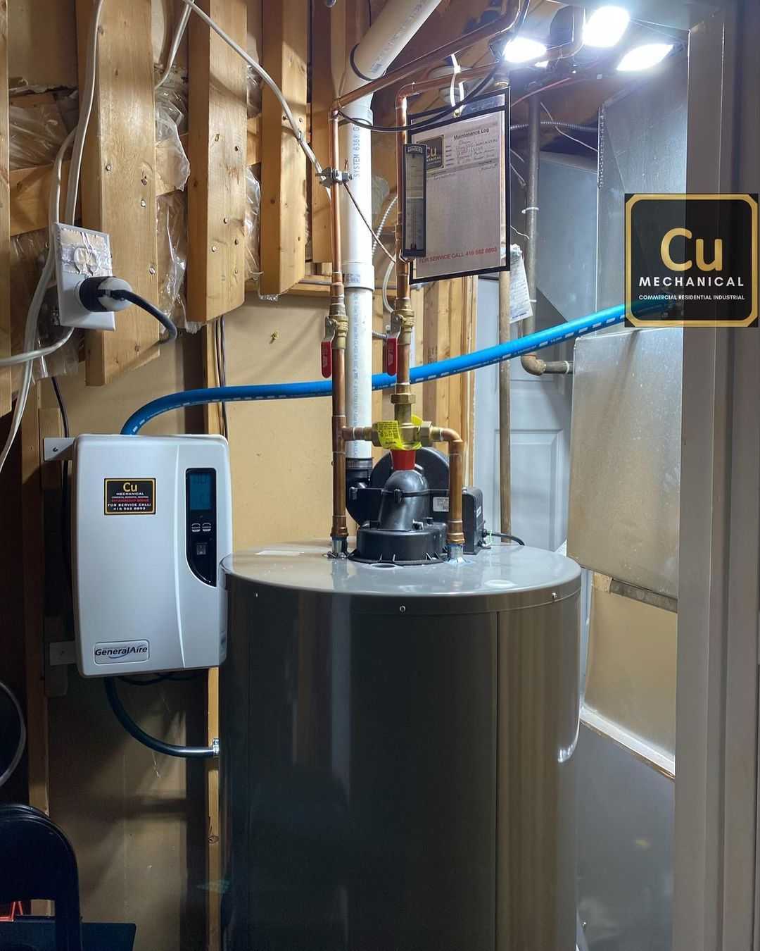 A water heater in a basement with a sign that says cu
