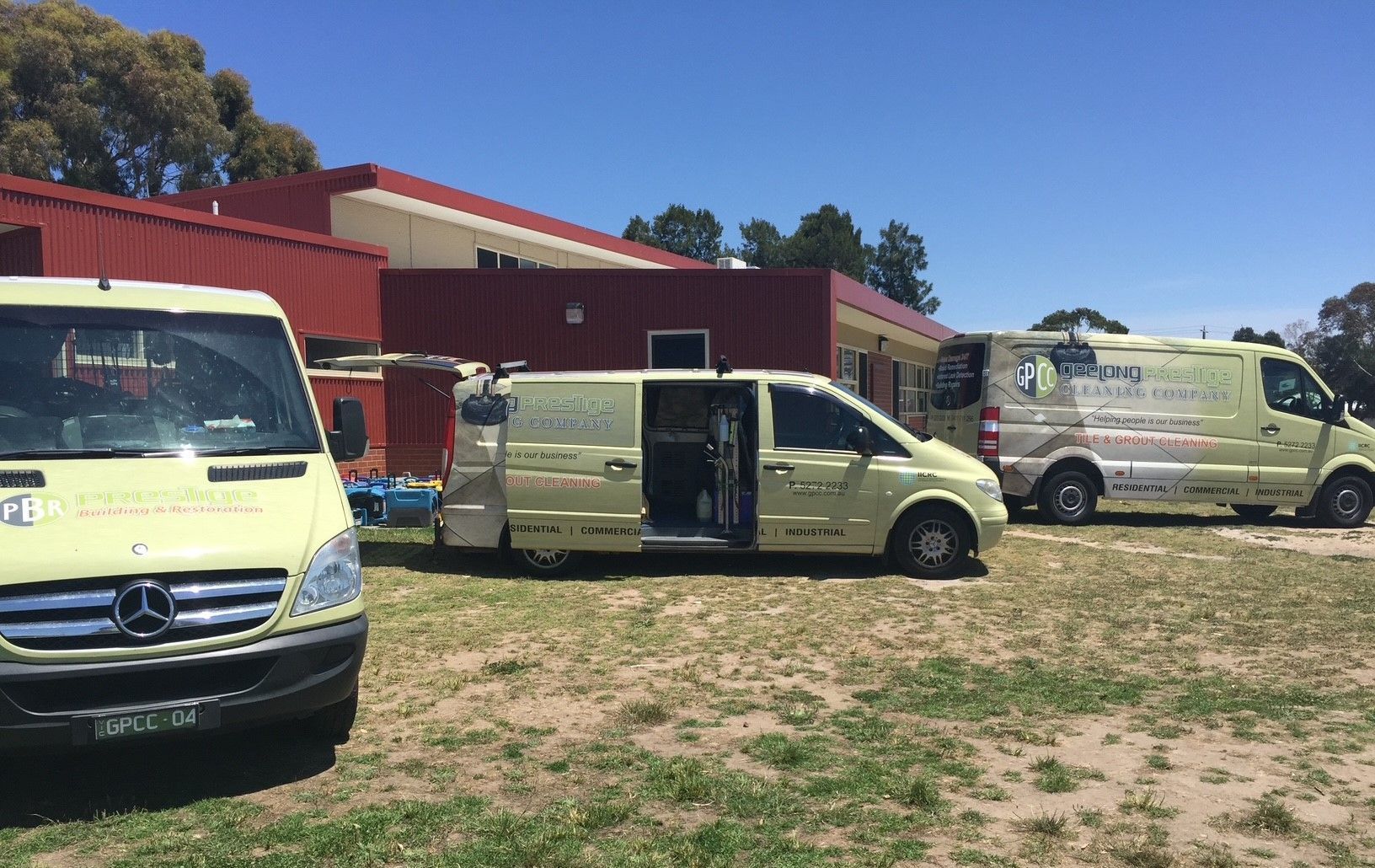 A woman is cleaning the floor with a mop in a hallway.