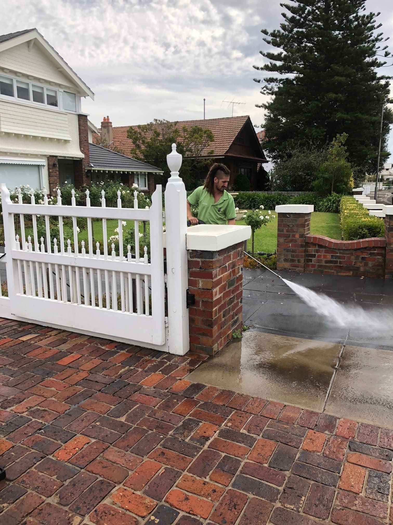 A person is using a pressure washer to clean a concrete floor.