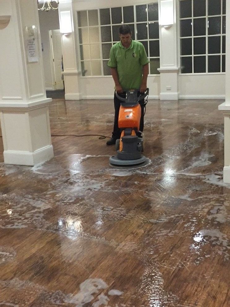 A close up of a shiny wooden floor in a room.