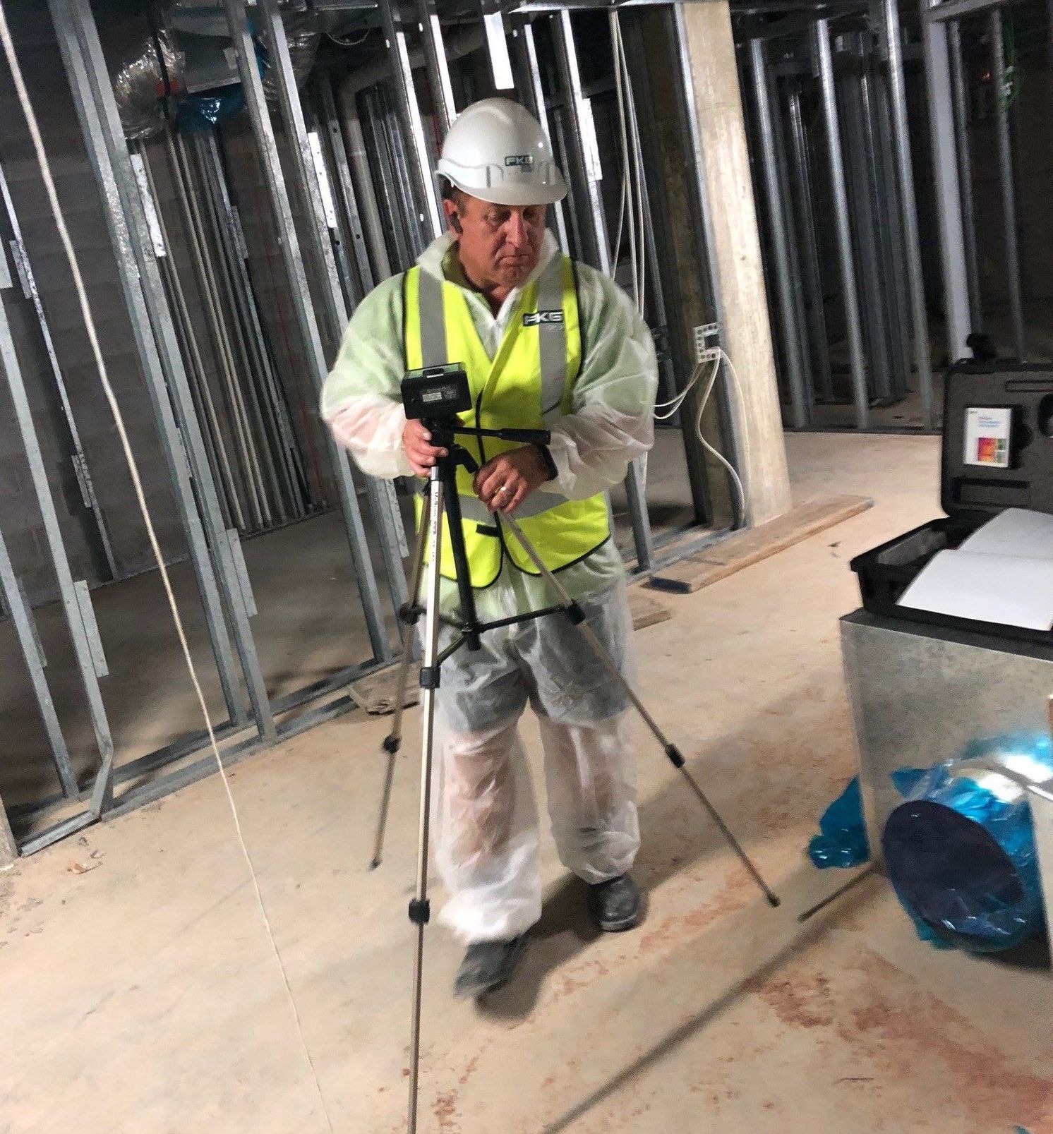 A woman is holding a little girl in her arms in a living room.