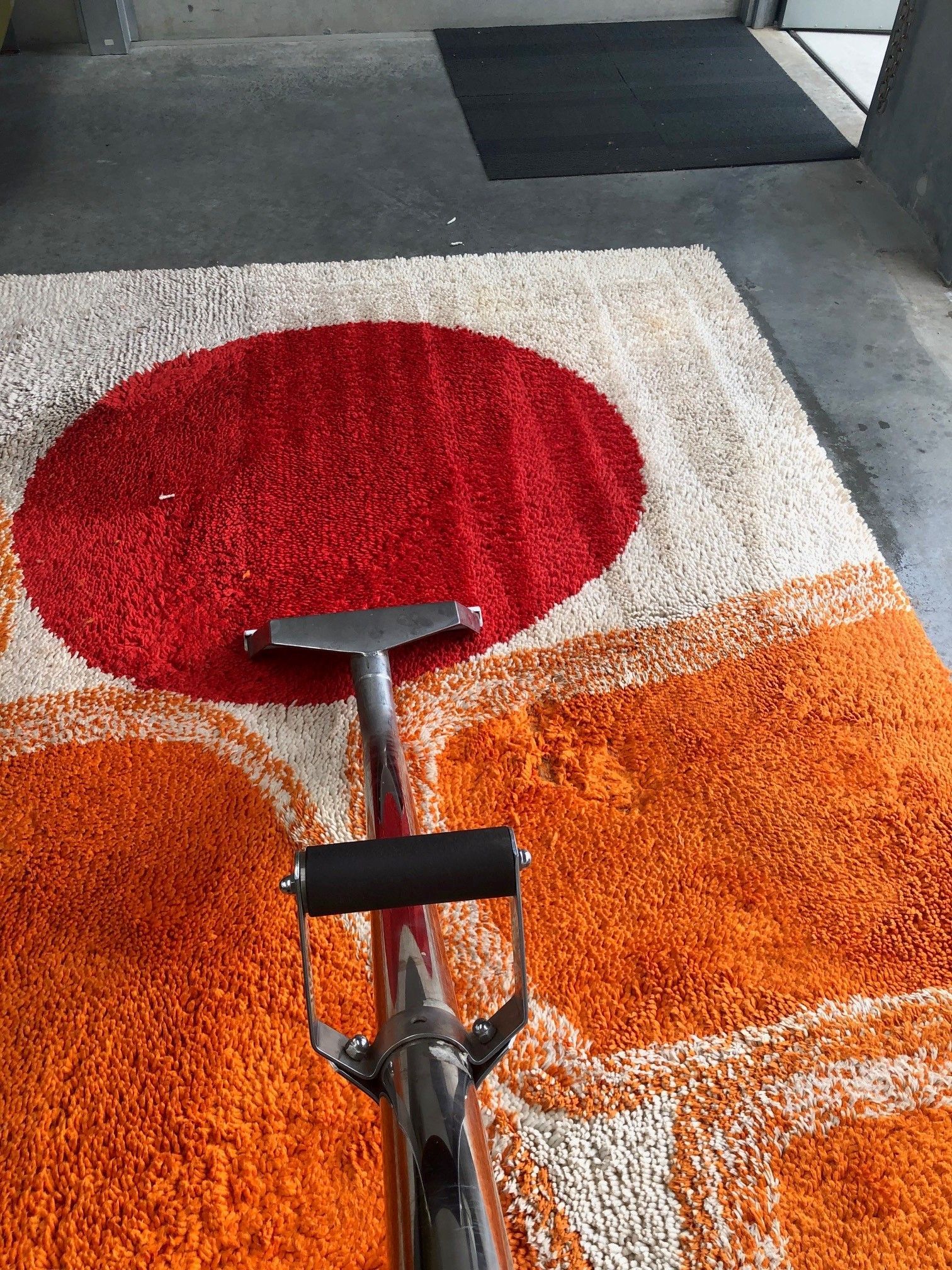 A man is cleaning a patio with a high pressure washer.