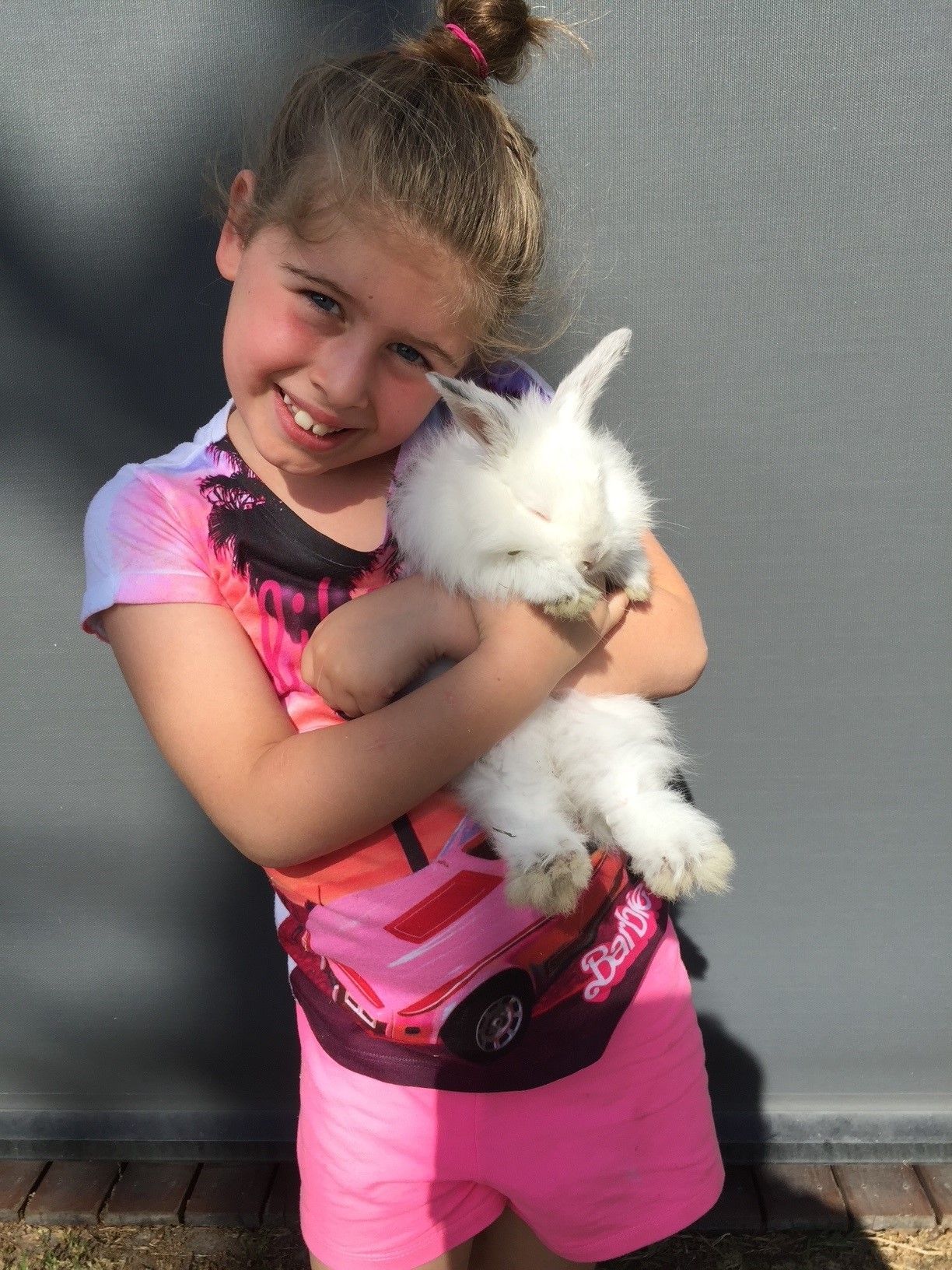 A man is spraying a wall with a sprayer.