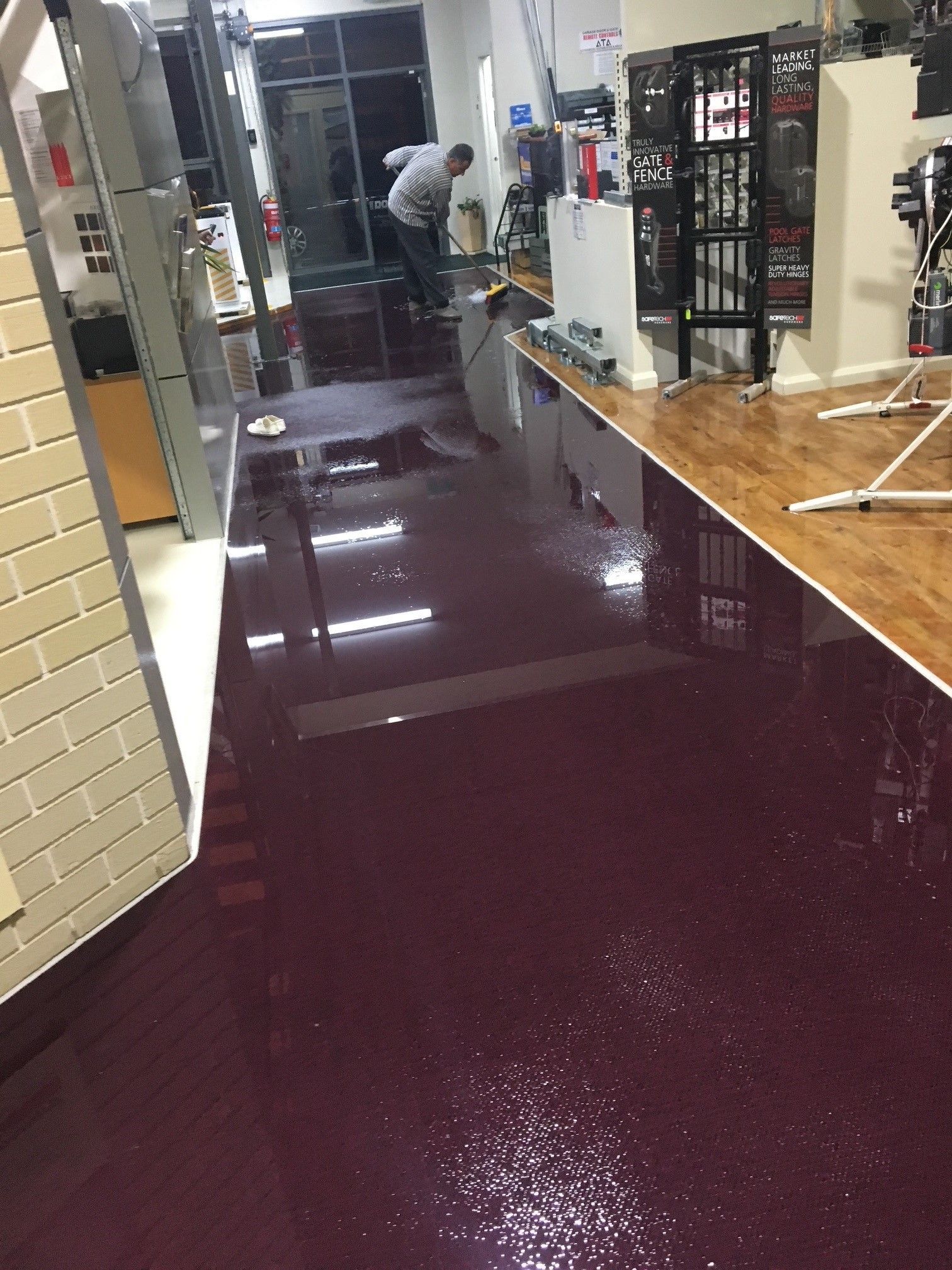 A man is spraying a wall with a sprayer.