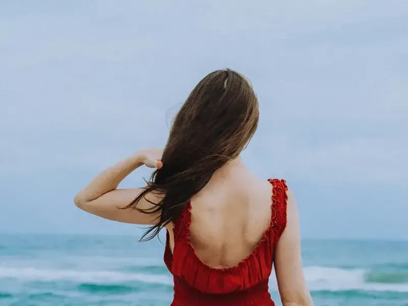 Woman by the ocean reflecting as she begins her grief counseling journey in Egg Harbor Township, NJ.