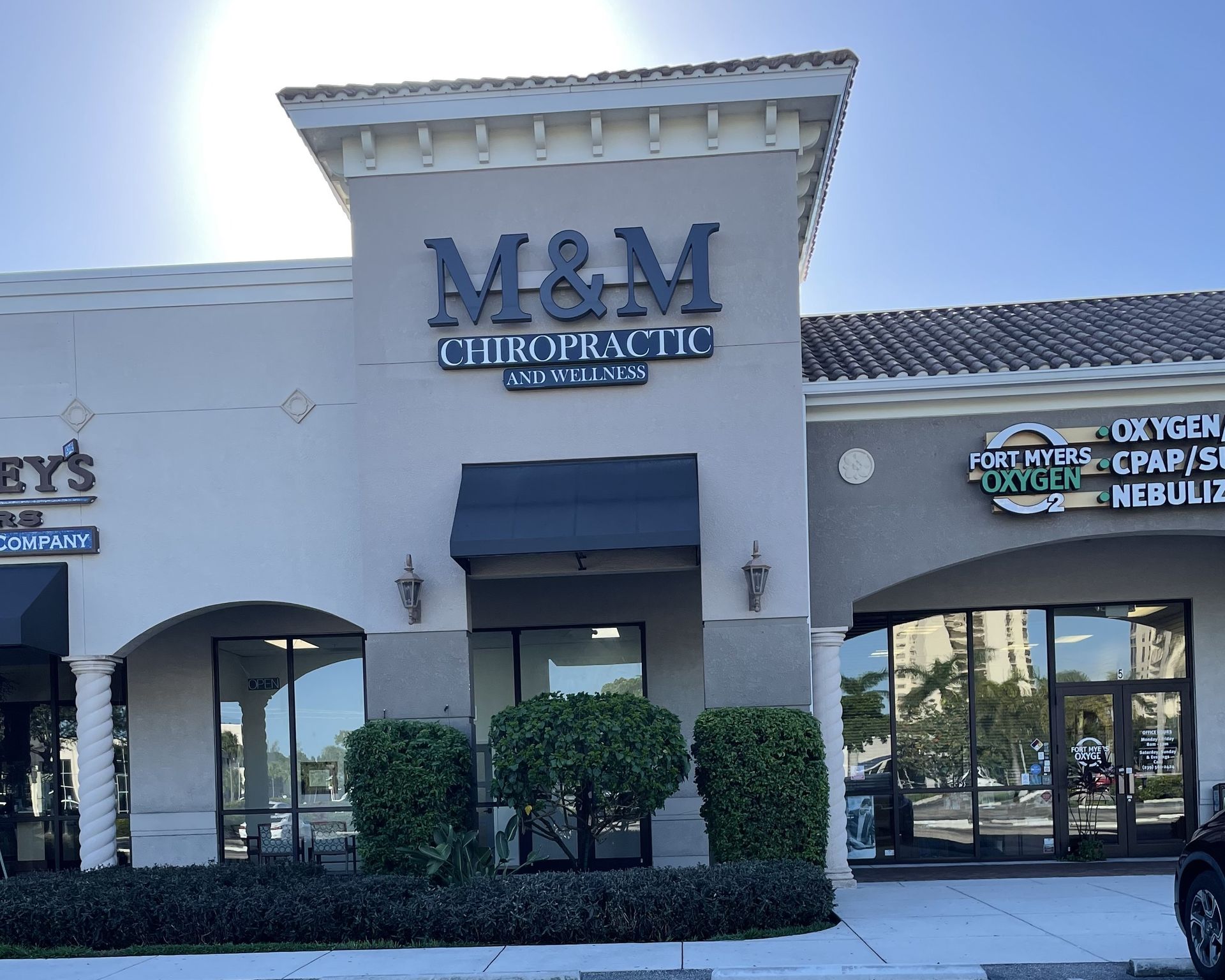 A m & m chiropractic building with a car parked in front of it