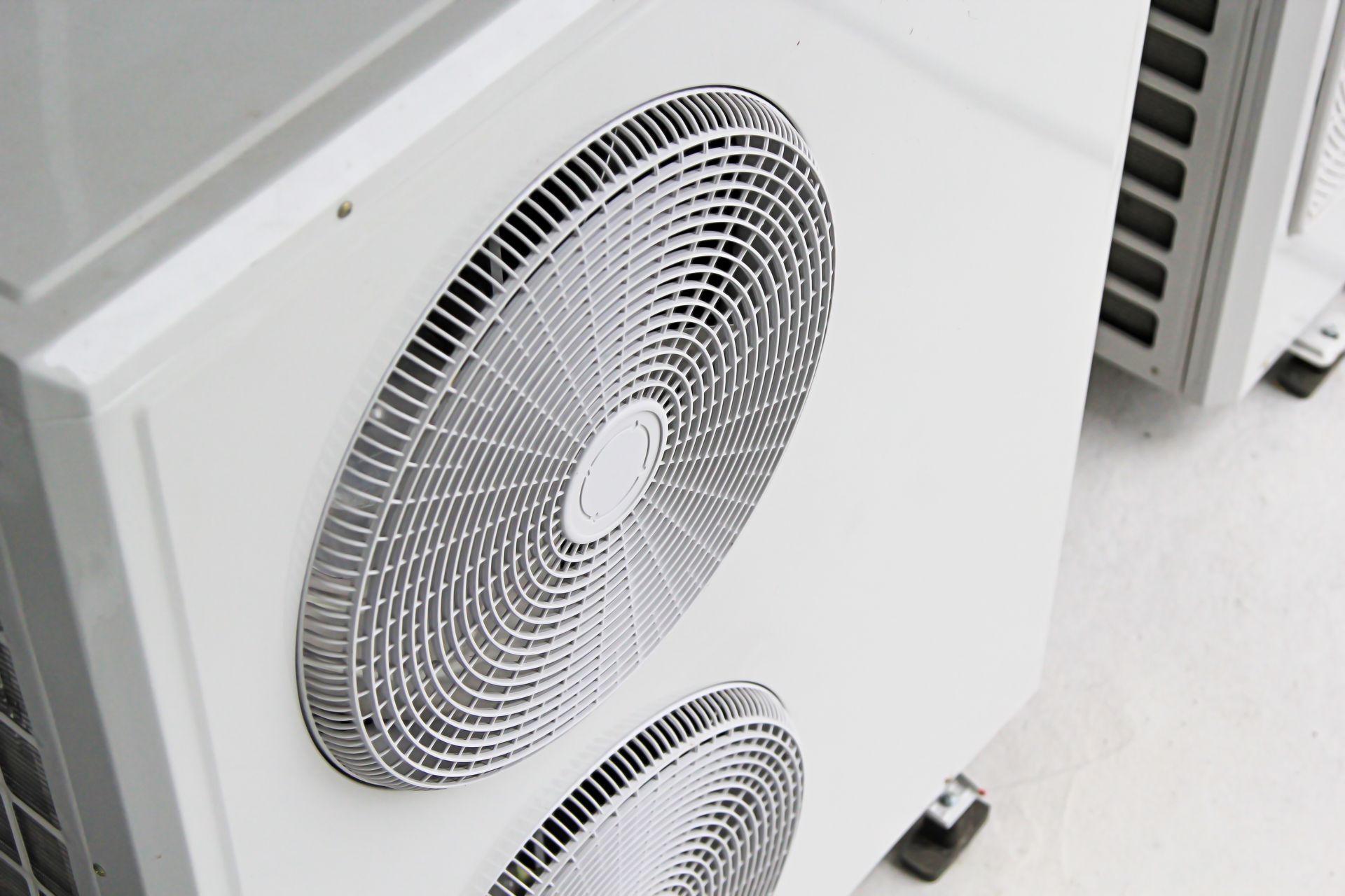 White air conditioning unit, close-up of fan and vents.