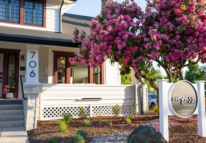 A house with a sign in front of it that says compass