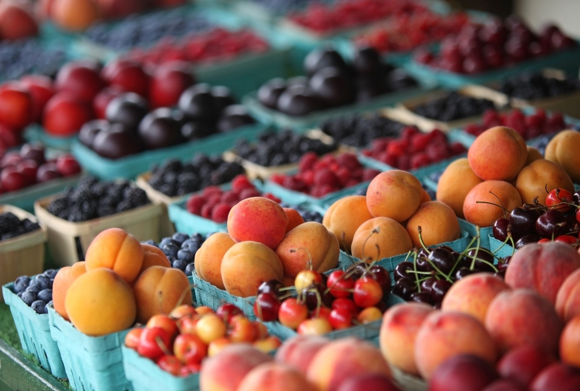 A variety of fruits and berries are displayed on a table.