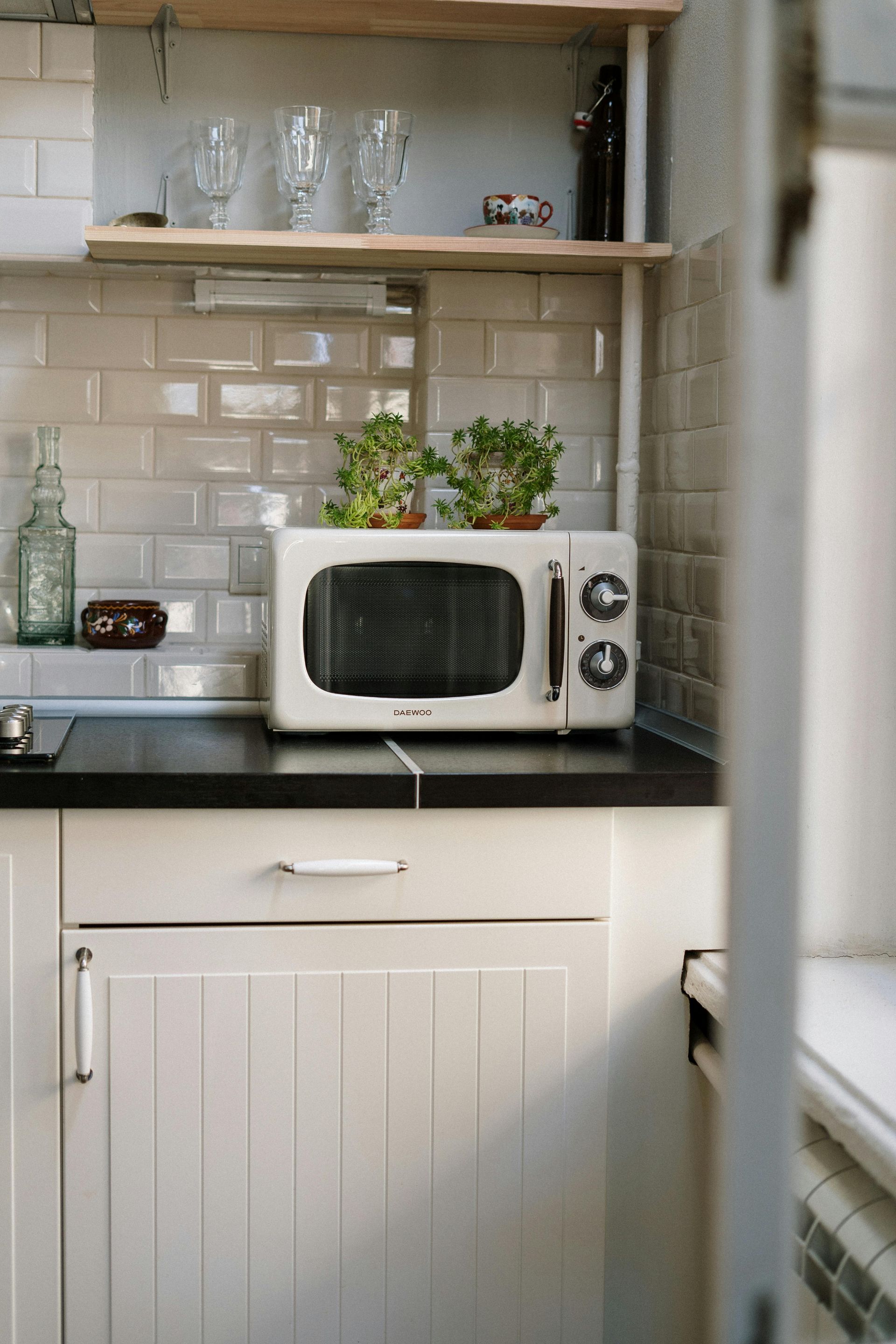 A microwave oven is sitting on top of a kitchen counter.