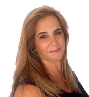 A woman with long blonde hair is wearing a black shirt and smiling.