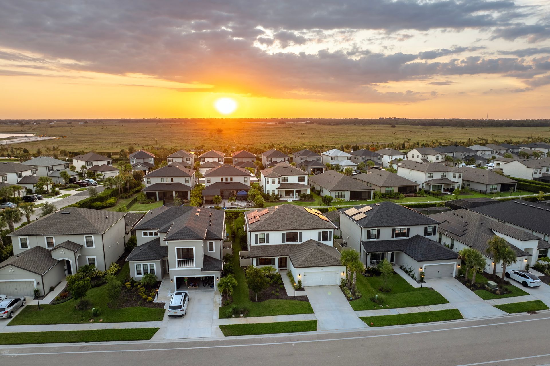 An aerial view of a residential neighborhood at sunset.