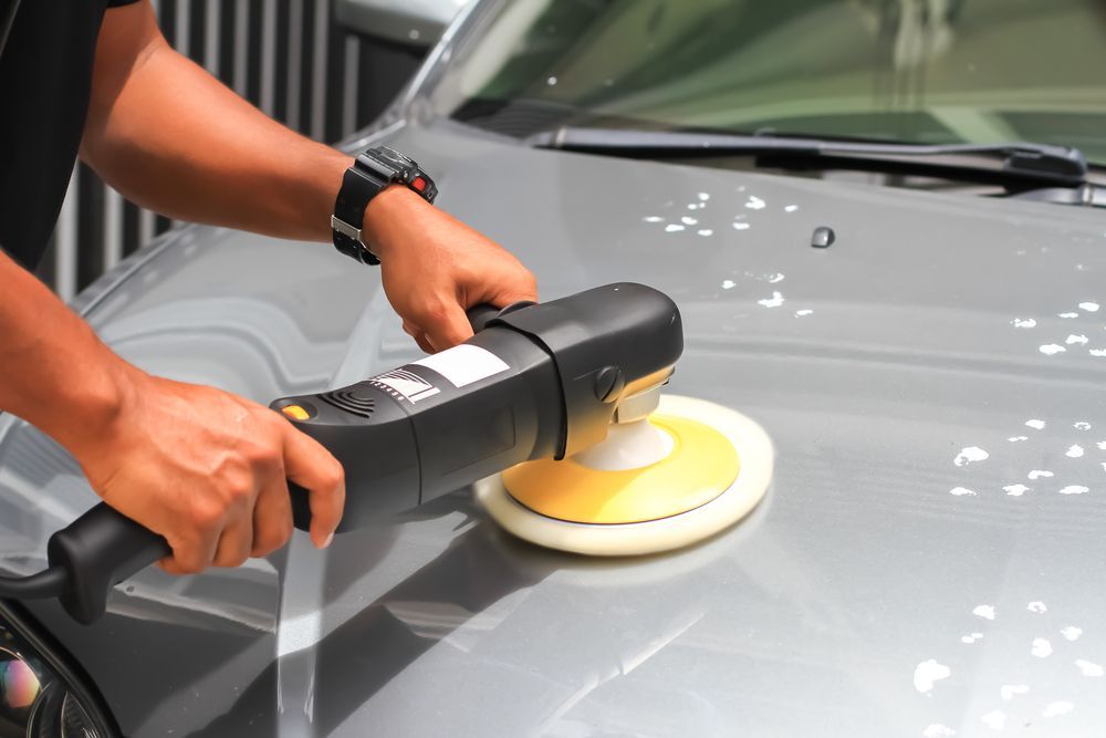 A Man Is Polishing A Car With A Machine β Townsville Car Care Centre In Aitkenvale, QLD
