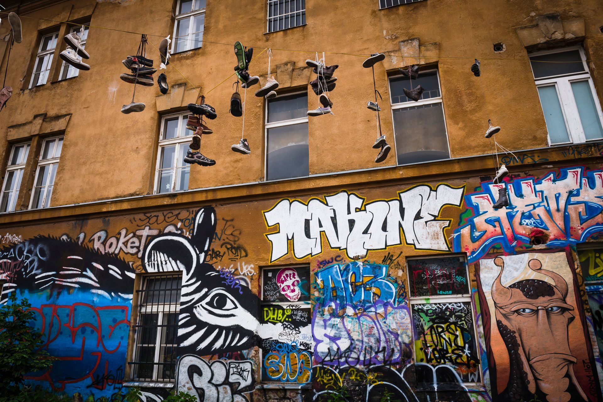graffiti and shoes hanging from wires