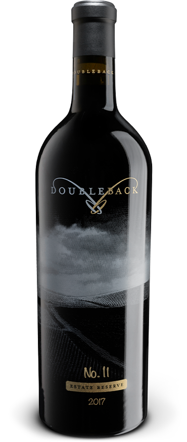 Black wine bottle with gold label and cap, labeled 
