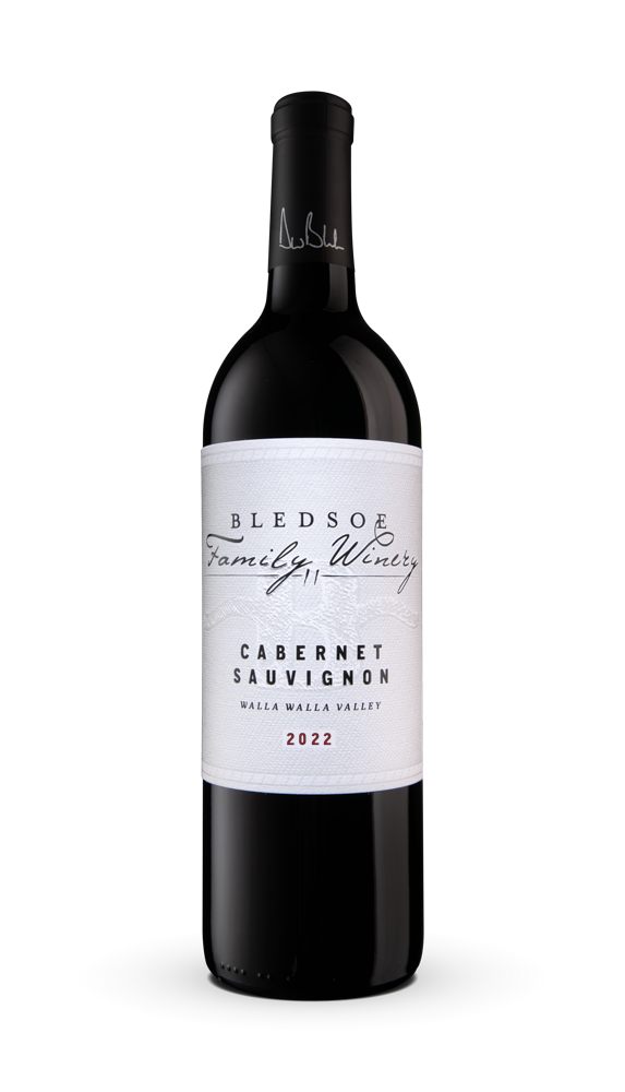 Bottle of red wine with a white label on a plain background