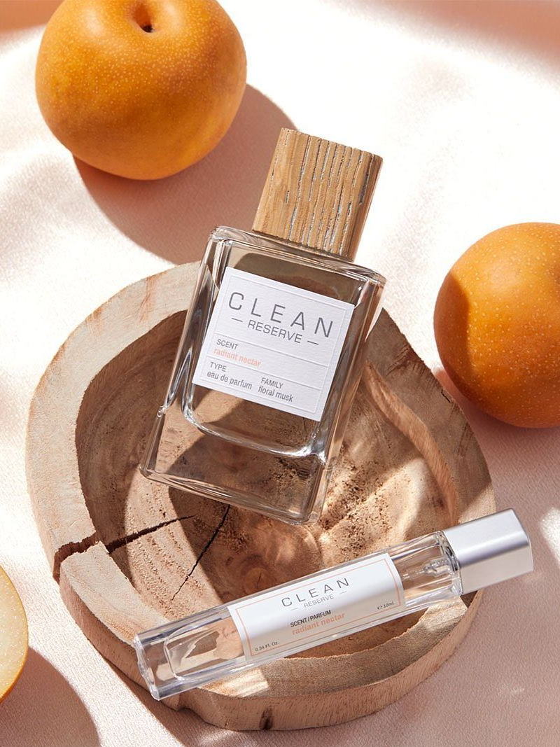 two bottles of frankincense and myrrh perfume from Haoma surrounded by flowers