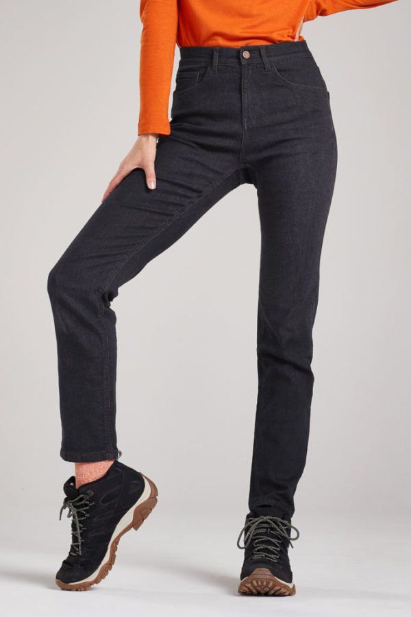 A woman wearing an orange shirt and black jeans