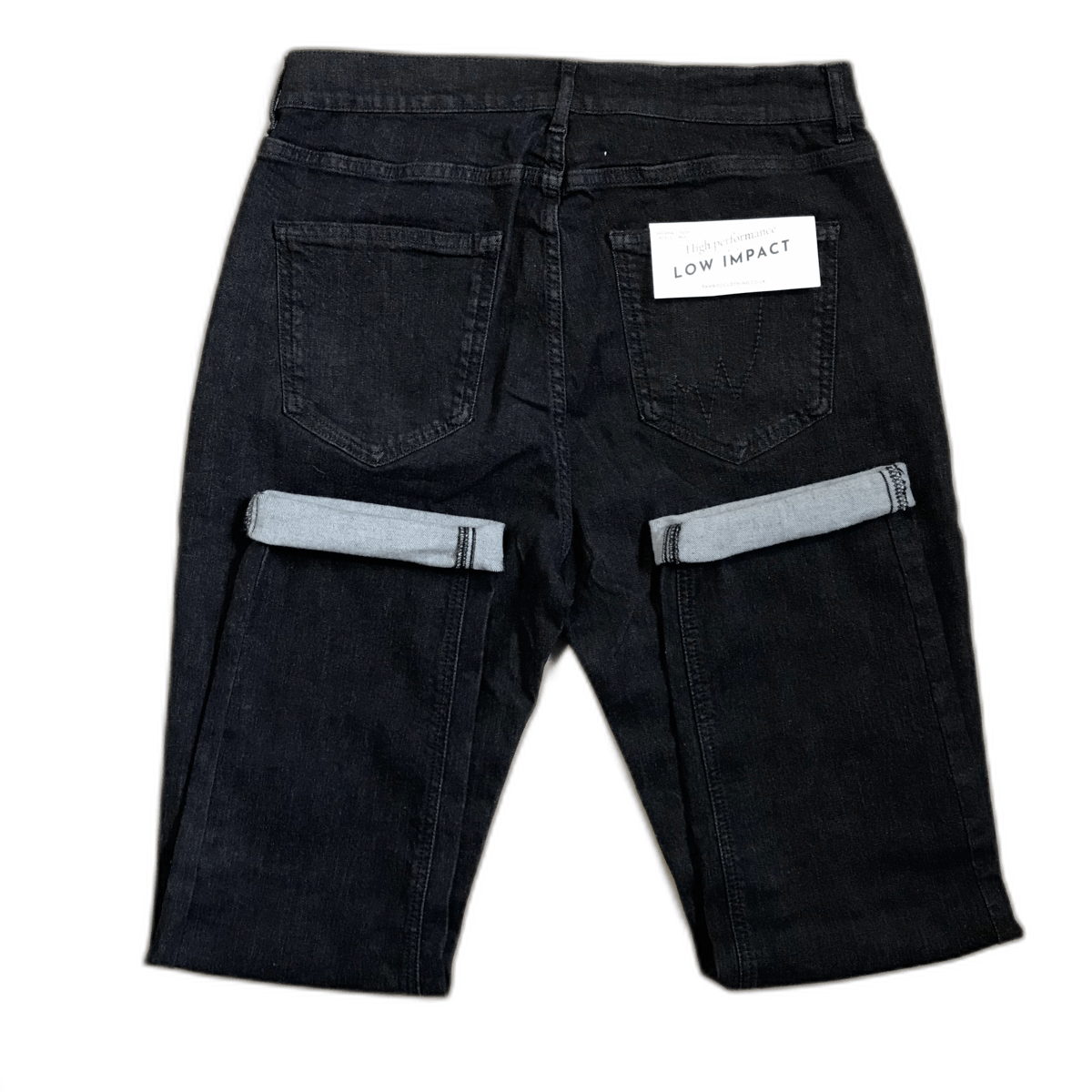 A pair of black jeans with a label that says low impact
