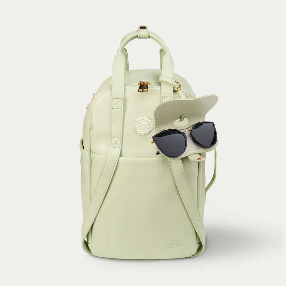 A white backpack with a pair of sunglasses attached to it.