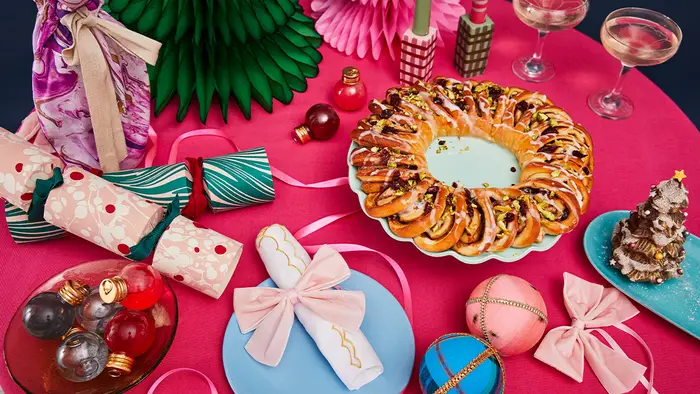 A table topped with plates of food and decorations for christmas.