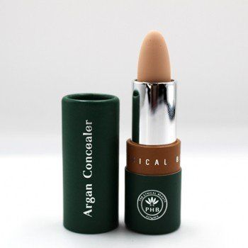 A tube of argan concealer sits next to a tube of lipstick