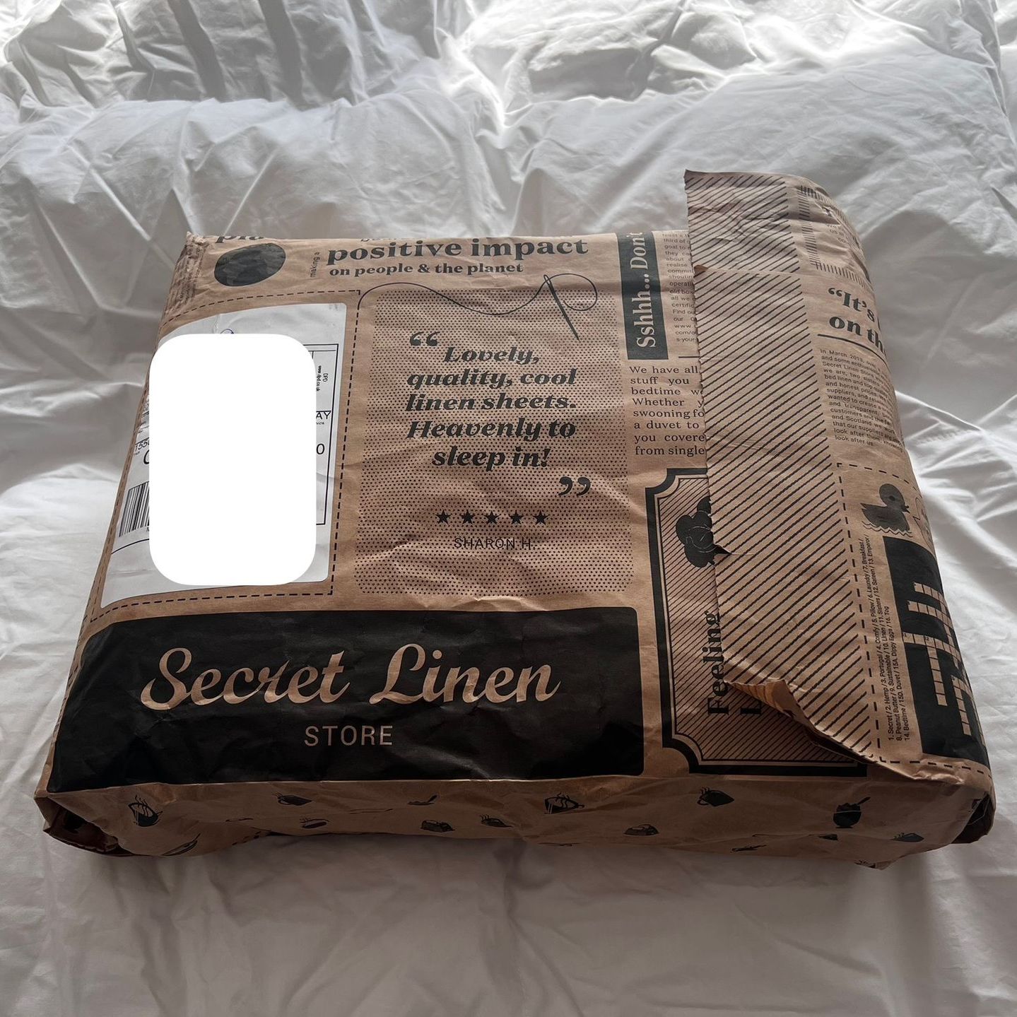 A package from secret linen store is wrapped in eco packaging