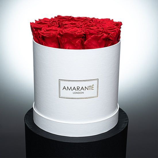 A white box filled with red roses from amarante london