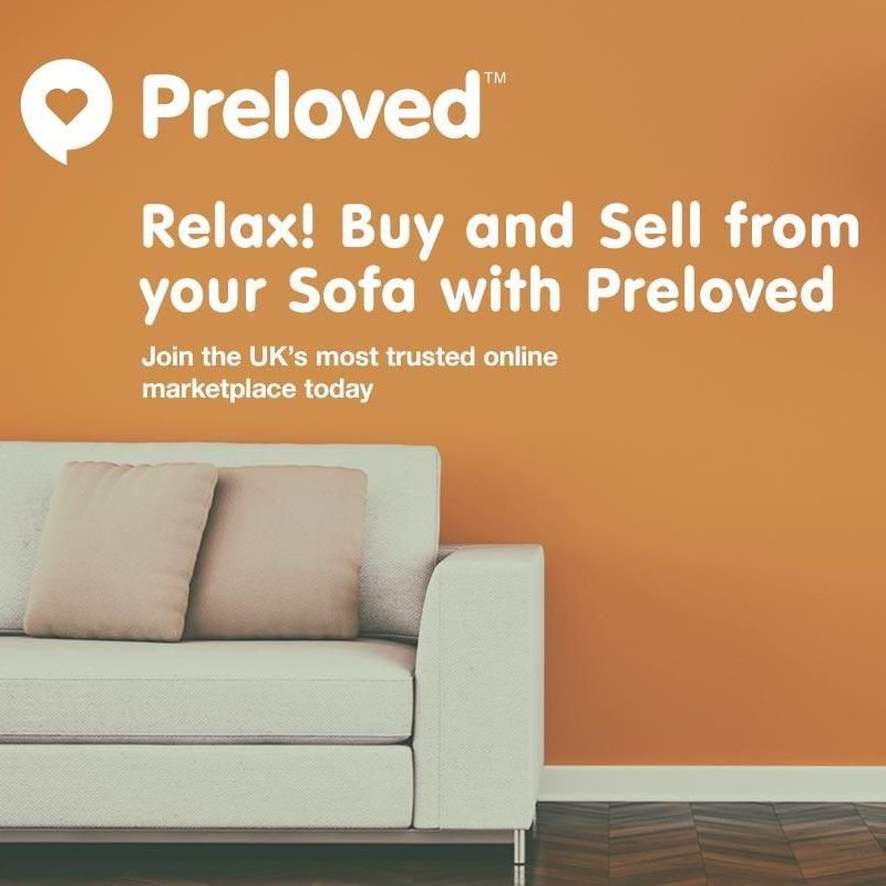 An advertisement for preloved shows a white couch in front of an orange wall