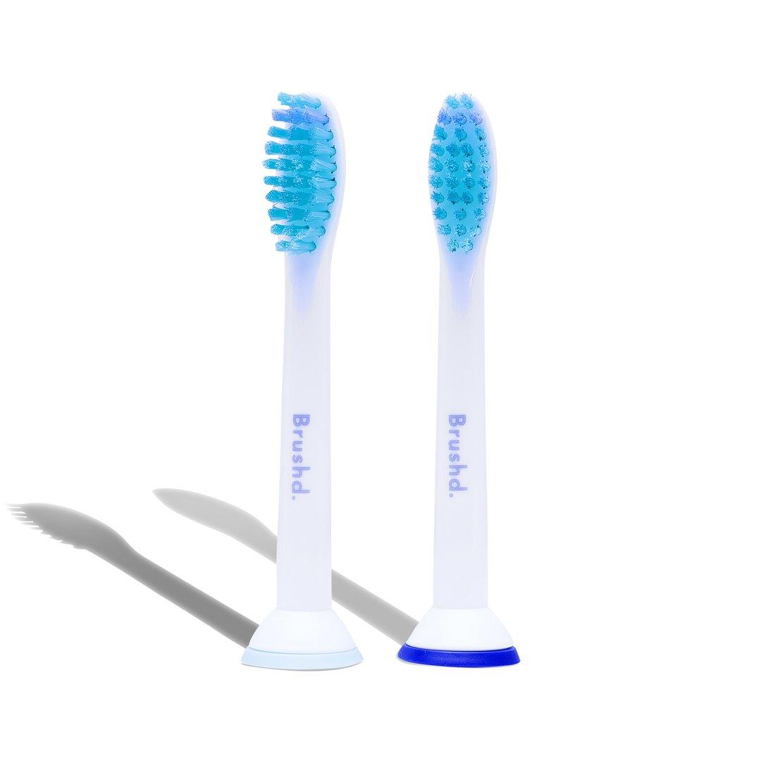 Two toothbrush heads with the word brushd on them