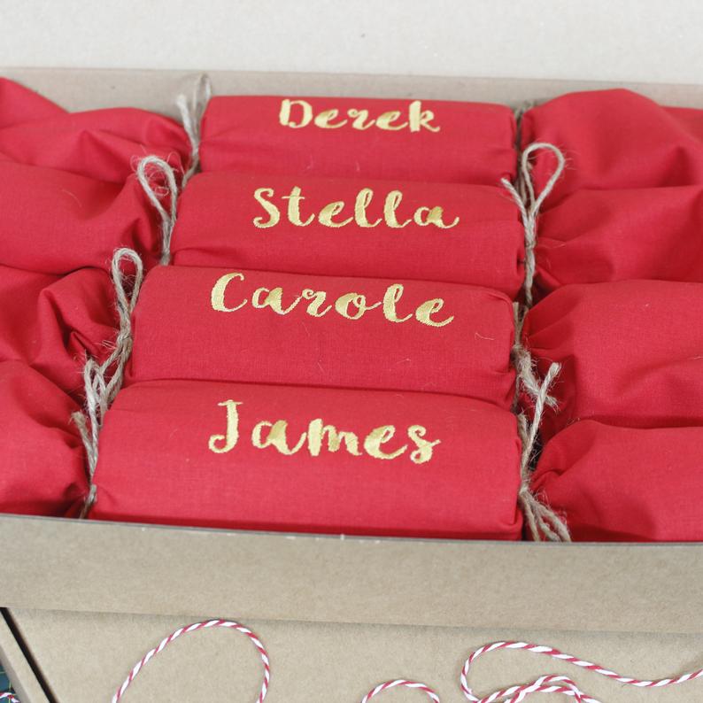 A box of red socks with the names derek stella carole and james on them