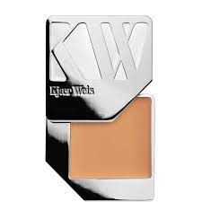A close up of Kjaer Weis foundation in a silver case on a white background.