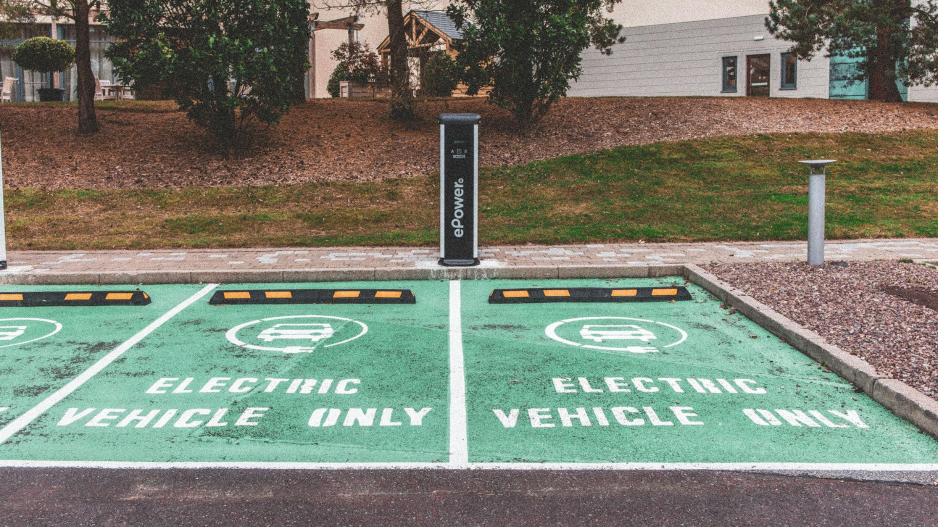 Man installing a solar panel on a rooftop, wearing safety glasses.