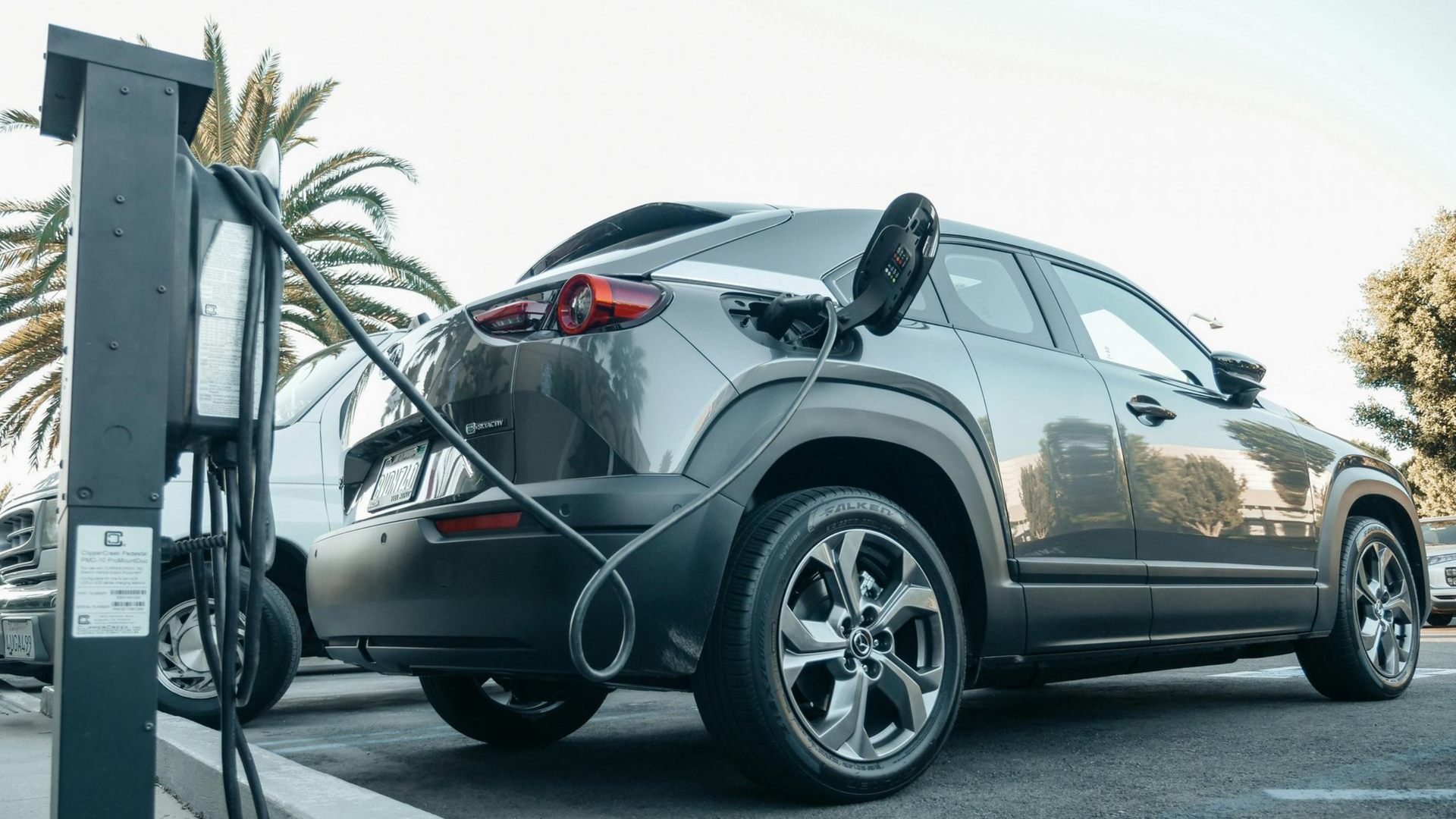 Man installing a solar panel on a rooftop, wearing safety glasses.