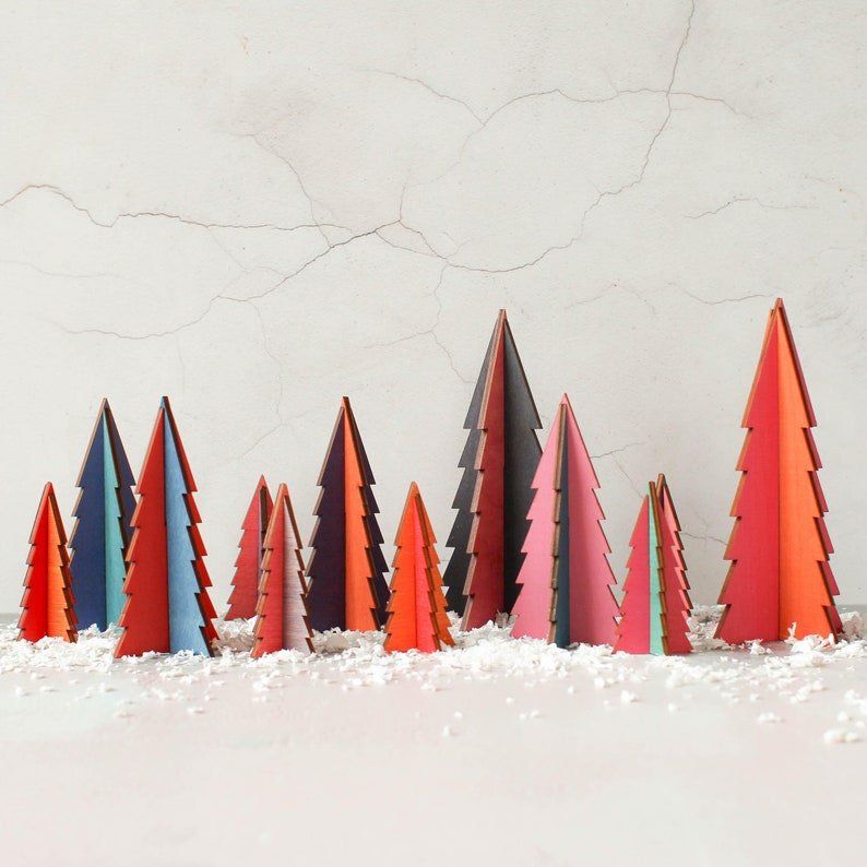 A row of colorful christmas trees in the snow