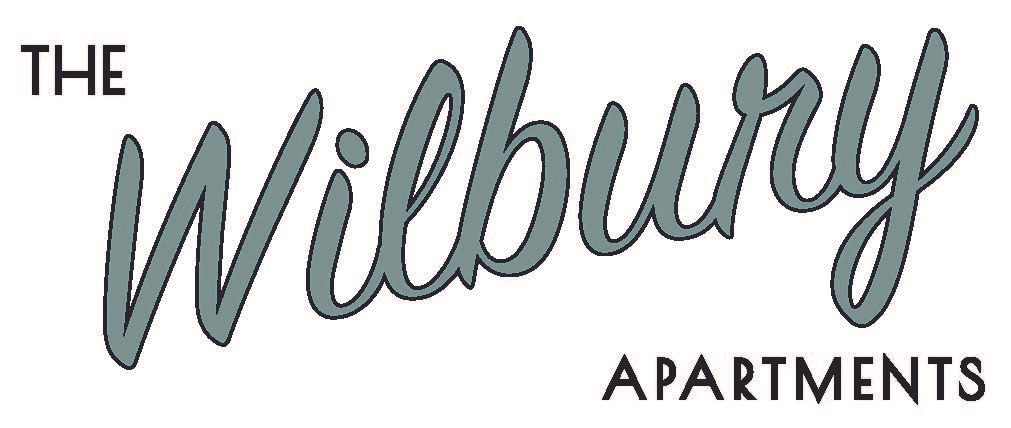 Logo for The Wilbury Apartments, featuring the word "Wilbury" in a gray, cursive font above "APARTMENTS" in black.