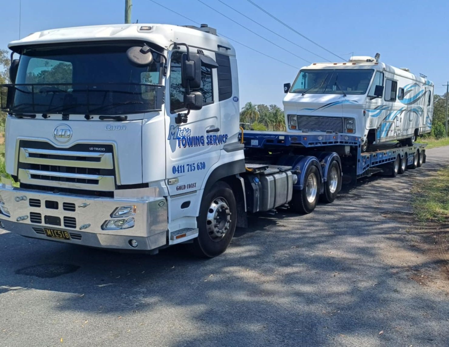 Motorhome on the Back of Large Tilt Tray Truck — Mick's Towing Service Pty Ltd in Carrara, QLD