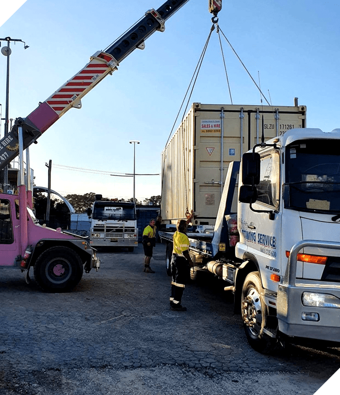 A Crane is Lifting a Shipping Container From a Truck — Mick’s Towing Service Pty Ltd in Carrara, QLD