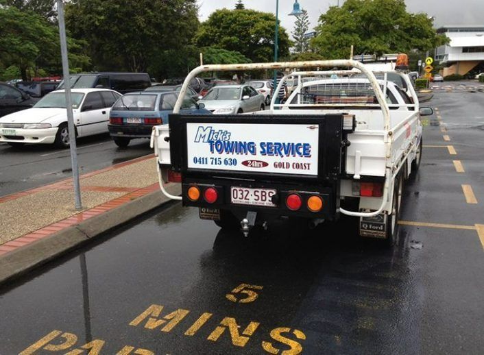 A Towing Service Truck is Parked in a Parking Lot — Mick's Towing Service Pty Ltd in Carrara, QLD