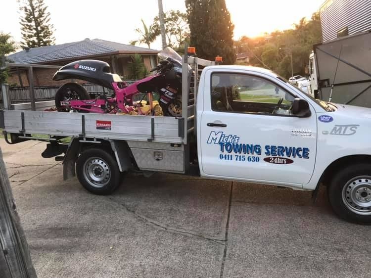 A White Towing Service Truck With a Pink Motorcycle in the Back — Mick's Towing Service Pty Ltd in Carrara, QLD